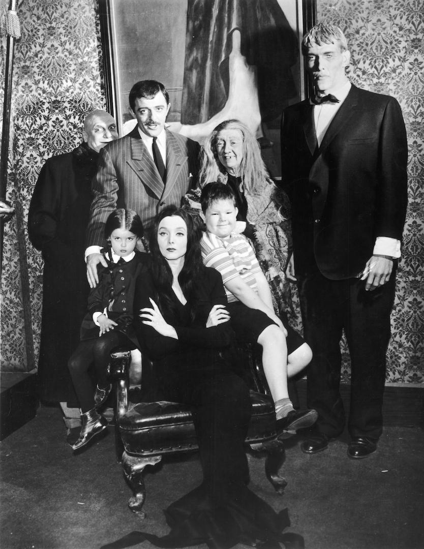 Standing (L-R): Jackie Coogan, John Astin, Blossom Rock, and Ted Cassidy. Sitting (L-R): Lisa Loring, Carolyn Jones, and Ken Weatherwax in a group portrait of the cast of the TV series "The Addams Family." (Hulton Archive/Getty Images)