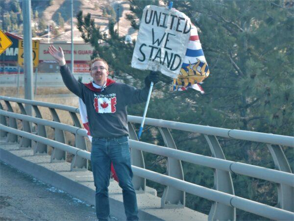 A man shows support to a convoy of vehicles outside Kamloops, B.C., on Jan. 28, 2023, to mark the one-year anniversary of trucker convoy protests against COVID-19 mandates. (Courtesy Bruce Orydzuk)