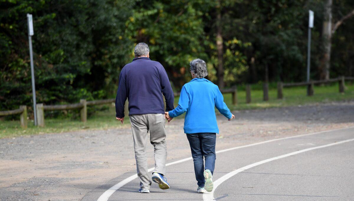 An elderly couple walk through a park in Sydney, Australia, on April 30, 2017. (AAP Image/Paul Miller)