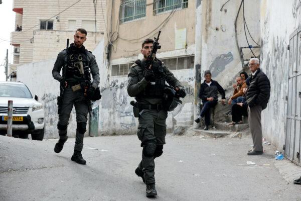 Israeli Border police officers walk outside the house of Palestinian gunman Khaire Alkam in A-Tur in East Jerusalem after Alkam shot dead at least seven people near a synagogue in Neve Yaacov, which lies on occupied land that Israel annexed to Jerusalem after the 1967 Middle East war, Jan. 28, 2023. (Ammar Awad/Reuters)