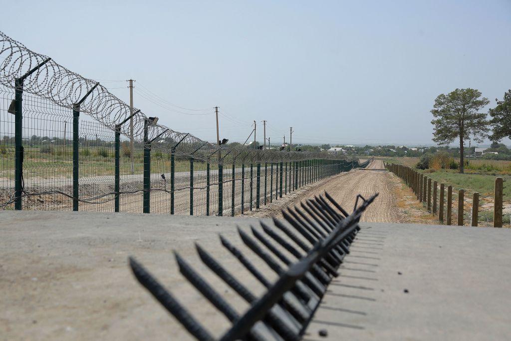 This picture taken on August 15, 2021, shows a barbed wire wall near a police checkpoint, two kilometers from "Friendship Bridge" over the Amu Darya River, which separates Uzbekistan and Afghanistan near Termez.(Temur Ismailov/AFP via Getty Images)