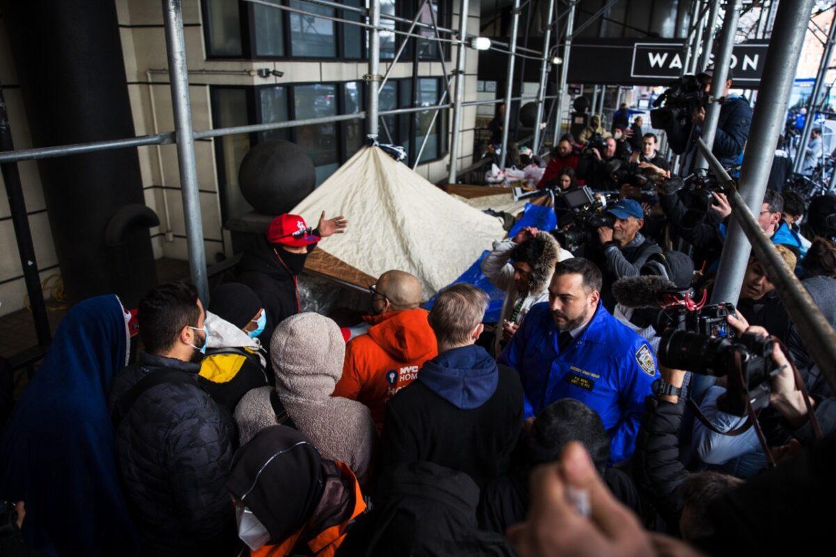 Illegal immigrants speak with NYC Homeless Outreach members as they camp out in front of the Watson Hotel after being evicted in New York City on Jan. 30, 2023. (Michael M. Santiago/Getty Images)