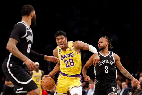 Rui Hachimura (28) of the Los Angeles Lakers dribbles against Markieff Morris (13) and Patty Mills (8) of the Brooklyn Nets during the first half at Barclays Center in New York on Jan. 30, 2023. (Sarah Stier/Getty Images)