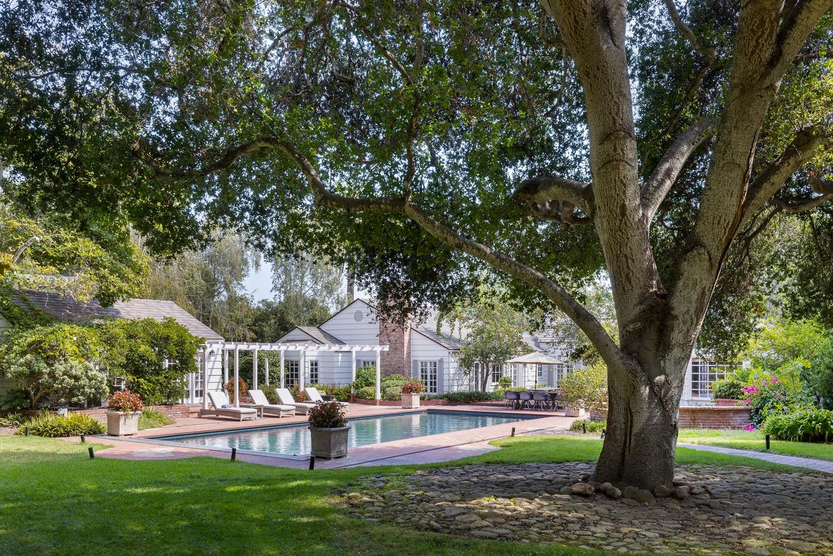 The property’s rear yard with the gazebo-accented pool house and sprawling landscaping makes the residence essentially a compact, private resort. (Matt Wier for Sotheby’s International Realty)
