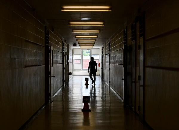 A teacher walks in the hallway of a junior public school in Ontario in a file photo. (The Canadian Press/Nathan Denette)