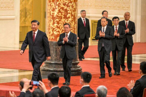 China's leader Xi Jinping (L) walks with (2nd L to R) Li Qiang, Li Xi, Zhao Leji, Ding Xuexiang, Wang Huning, and Cai Qi, members of the Chinese Communist Party's new Politburo Standing Committee in the Great Hall of the People in Beijing on Oct. 23, 2022. (Wang Zhao/AFP via Getty Images)