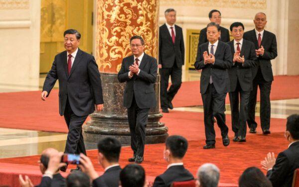 Chinese leader Xi Jinping walks with (2nd L–R) Li Qiang, Li Xi, Zhao Leji, Ding Xuexiang, Wang Huning, and Cai Qi, members of the Chinese Communist Party's new Politburo Standing Committee, the nation's top decision-making body, as they meet the media in the Great Hall of the People in Beijing on Oct. 23, 2022. (Wang Zhao/AFP via Getty Images)