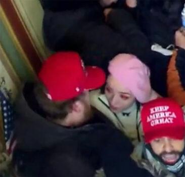 Pink Beret "getting cozy with a male protester" at the U.S. Capitol on Jan. 6, 2021, according to defense attorney Kira West. (U.S. District Court/Screenshot via The Epoch Times)