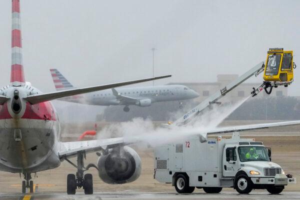 An American Airlines aircraft undergoes deicing procedures at Dallas/Fort Worth International Airport in Texas, on Jan. 30, 2023. (Lola Gomez/The Dallas Morning News via AP)