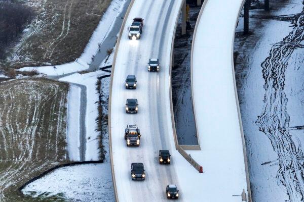 An icy mix covers Highway 114 in Roanoke, Texas, on Jan. 30, 2023. (Smiley N. Pool/The Dallas Morning News via AP)