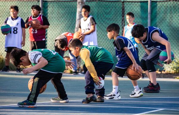 Children dribble basketballs in Fullerton, Calif., on Feb. 1, 2023. (John Fredricks/The Epoch Times)