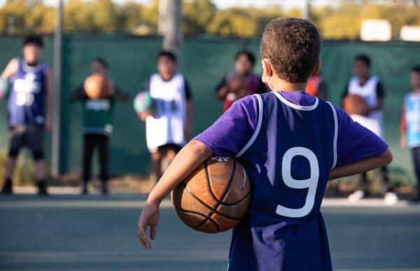 Children take part in a one-hour basketball training session hosted by the YMCA of Orange County in Fullerton, Calif., on Feb. 1, 2023. (John Fredricks/The Epoch Times)