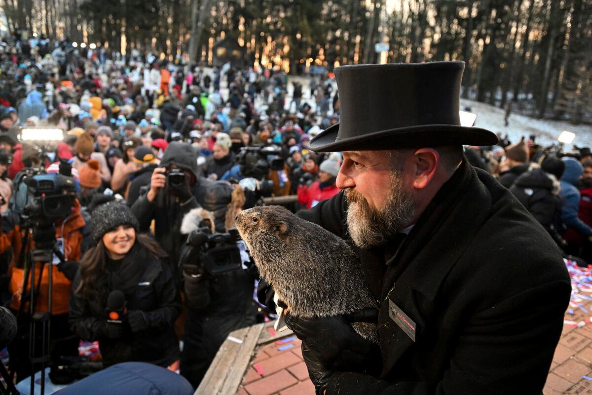 Groundhog Club handler A.J. Dereume holds Punxsutawney Phil, the weather prognosticating groundhog, during the 137th celebration of Groundhog Day on Gobbler's Knob in Punxsutawney, Pa., on Feb. 2, 2023. (Barry Reeger/AP Photo)