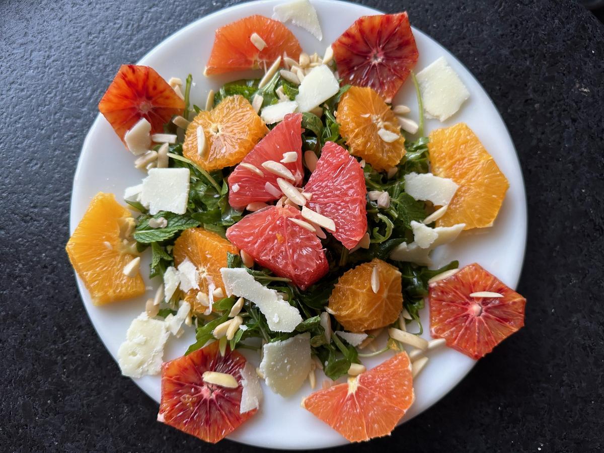 This salad delivers every known category of flavor, with arugula coinciding with spicy black pepper, onions, and garlic, alongside bitter pith and sweet, tart fruit. (Ari LeVaux)