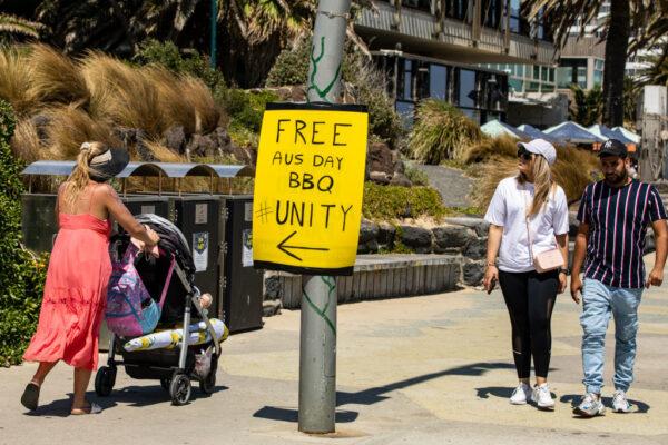 A sign referring to Australia Day is seen at St. Kilda beach as people walk past in Melbourne, Australia, on Jan. 26, 2022. (Diego Fedele/Getty Images)
