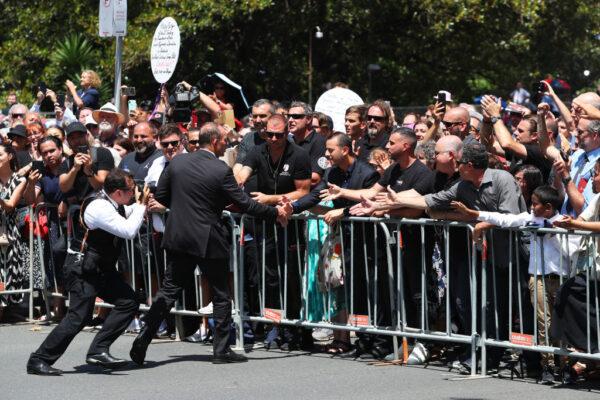 Former Australian Prime Minister Tony Abbott reaches out to supporters as he walks with the procession behind the hearse carrying Cardinal George Pell outside St. Mary’s Cathedral on February 02, 2023 in Sydney, Australia. (Photo by Lisa Maree Williams/Getty Images)