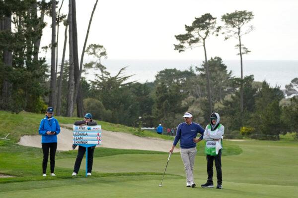 Hank Lebioda, second from right, waits to putt on the 18th green of the Monterey Peninsula Country Club Shore Course during the first round of the AT&T Pebble Beach Pro-Am golf tournament in Pebble Beach, Calif., on Feb. 2, 2023. (Eric Risberg/AP Photo)