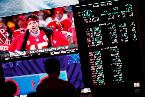 A person gambles as betting odds for NFL football's Super Bowl are displayed on monitors at the Circa resort and casino sports book in Las Vegas on Feb. 3, 2023. (John Locher/AP Photo)