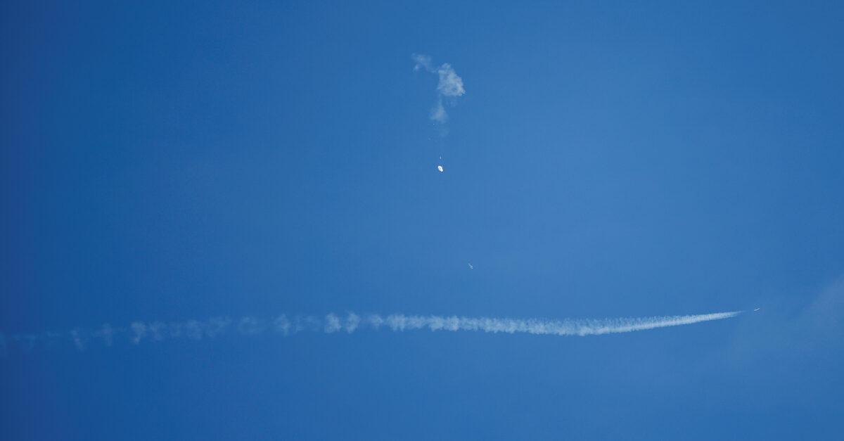 A jet flies by a Chinese spy balloon after shooting it down off the coast in Surfside Beach, S.C., on Feb. 4, 2023. (Randall Hill/Reuters)