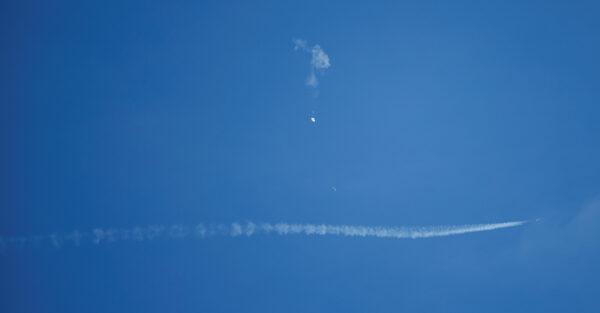 A jet flies by a Chinese spy balloon after shooting it down off the coast in Surfside Beach, South Carolina, on Feb. 4, 2023. (Randall Hill/Reuters)