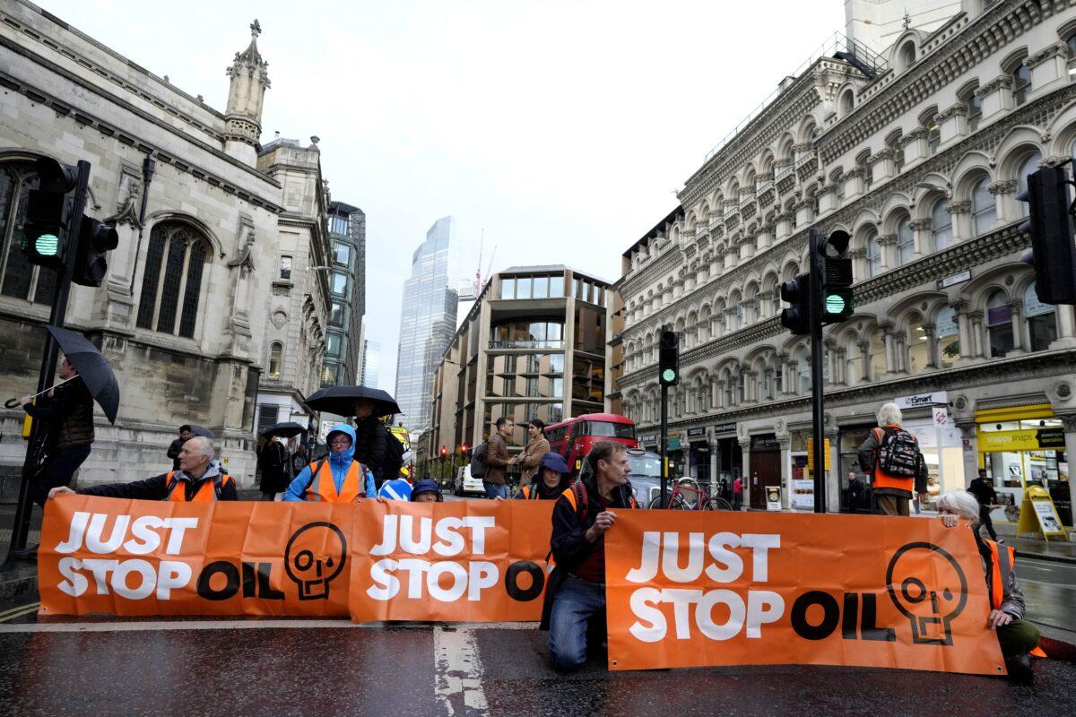 Activists from the group Just Stop Oil block a road in London, on Oct. 27, 2022. (Kirsty Wigglesworth/AP Photo)