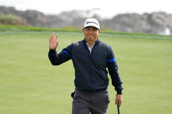 Kurt Kitayama waves after making a birdie putt on the eighth green of the Pebble Beach Golf Links during the second round of the AT&T Pebble Beach Pro-Am golf tournament in Pebble Beach, Calif., on Feb. 3, 2023. (Eric Risberg/AP Photo)