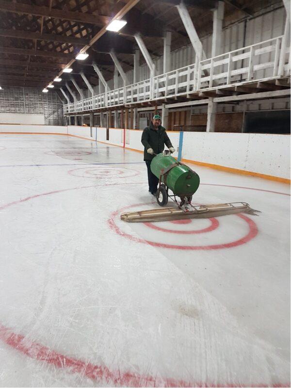 Volunteers at the ice rink in Lang, Saskatchewan, use a homemade machine to resurface the ice. (Courtesy Mike Williams)