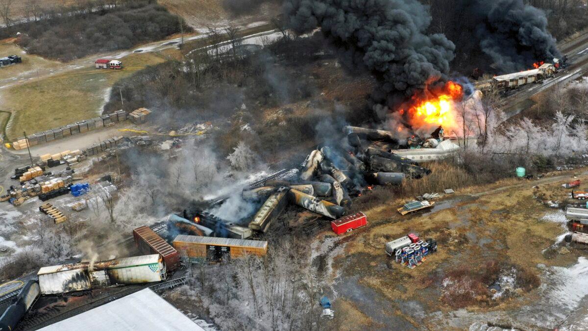 Portions of a Norfolk and Southern freight train that derailed a day earlier in East Palestine, Ohio, are still on fire at mid-day on Feb. 4, 2023. (Gene J. Puskar/AP Photo)