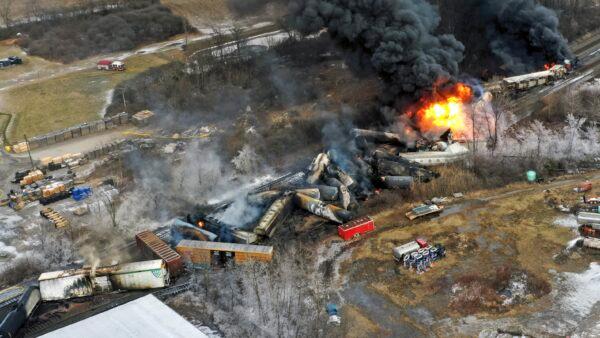 Portions of a Norfolk and Southern freight train that derailed in East Palestine, Ohio, are still on fire at midday the next day, Feb. 4, 2023. (Gene J. Puskar/AP Photo)
