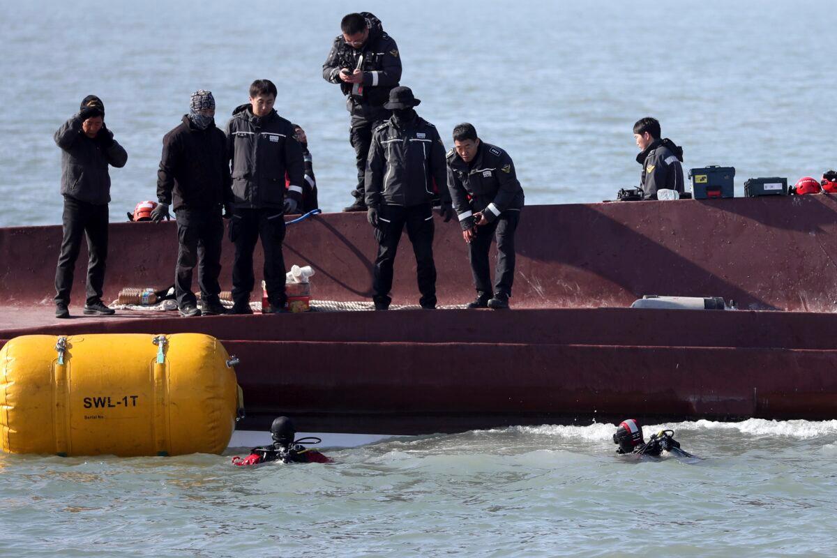 Members of a rescue team search for people from a capsized boat in waters off the country's southwestern coast in South Korea on Feb. 5, 2023. (Jung Hee-sung/Yonhap via AP)