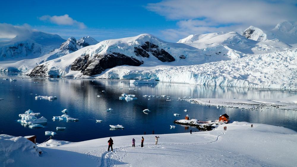 Tourists enjoy the frigid beauty of Paradise Bay, Antarctica. (chrisontour84/Shutterstock)