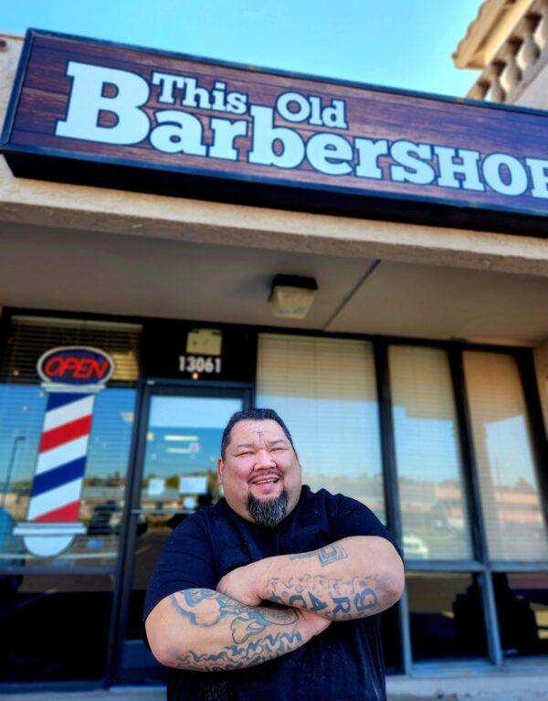 This Old Barbershop owner Luis Bermudez in Phoenix, Ariz., stands in front of his traditional barbershop on Jan. 26, 2023. (Allan Stein/The Epoch Times)