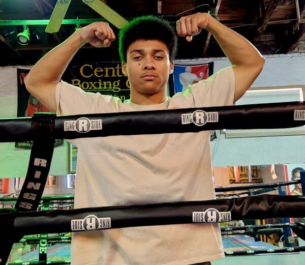 Amateur boxer Brian Viera, 20, flexes his biceps after a quick workout in the ring at Central Boxing Gym in Phoenix, Ariz., on Jan. 26, 2023. (Allan Stein/The Epoch Times)