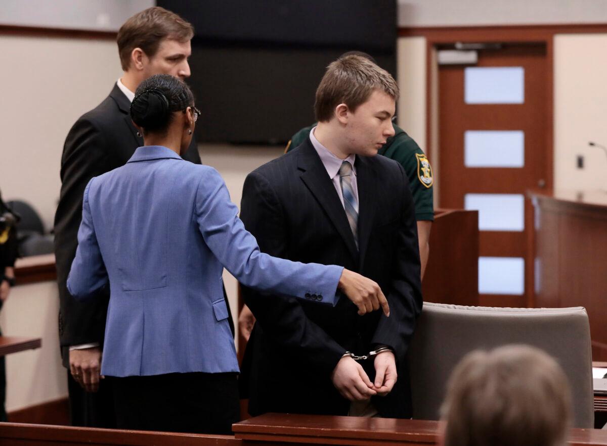 Aiden Fucci is directed to his seat by his attorneys as he entered the Saint Johns County Courtroom of Judge R. Lee Smith in St. Augustine, Fla., on Feb. 6, 2023. (Bob Self/The Florida Times-Union via AP)