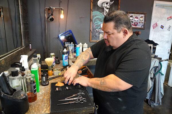 This Old Barbershop owner Luis Bermudez gets ready for his next customer in Phoenix, Ariz., on Jan. 26, 2013. (Allan Stein/The Epoch Times)