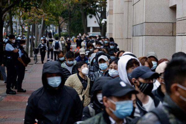 People queue outside the West Kowloon Magistrates’ Courts during the hearing of the 47 pro-democracy activists charged with conspiracy to commit subversion under the national security law, in Hong Kong, on Feb. 6, 2023. (Tyrone Siu/Reuters)