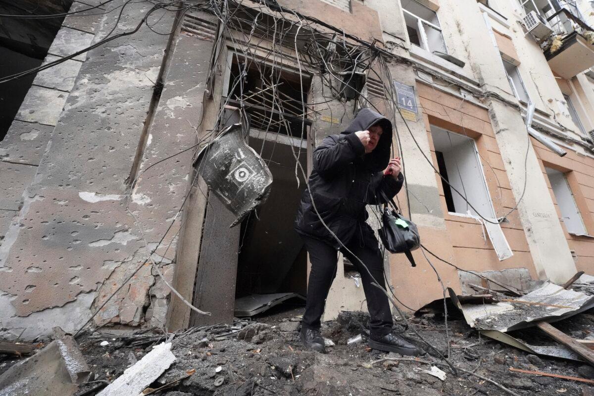 A woman walks out from a residential building which was hit by a Russian rocket in the city center of Kharkiv, Ukraine, on Feb. 5, 2023. (Andrii Marienko/AP Photo)