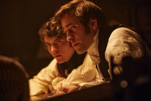 Emily Brontë's brother Branwell (Fionn Whitehead, L) and curate William Weightman (Oliver Jackson-Cohen), in "Emily." (Warner Bros.)