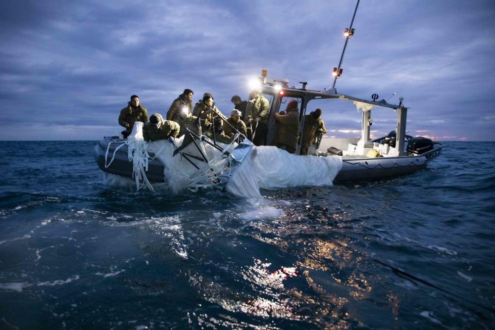 Sailors assigned to Explosive Ordnance Disposal Group 2 are seen working to recover the balloon near South Carolina's coast on Feb. 5, 2023. (U.S. Navy Photo by Mass Communication Specialist 1st Class Tyler Thompson)