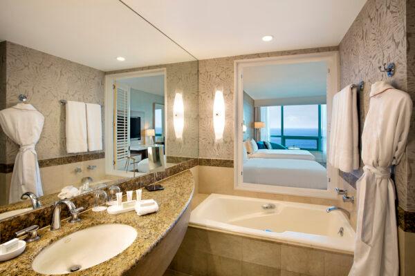 The bathrooms in the Diplomat are like a multi-room suite onto themselves, featuring a separate room for the shower and the toilet, and a tub that has shutters that can be opened up to enjoy the view of the Atlantic or Intercoastal. (Courtesy of the Diplomat Beach Resort)