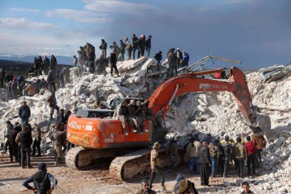 Rescuers search the rubble of buildings for casualties and survivors in the village of Besnaya in Syria's rebel-held northwestern Idlib province at the border with Turkey following an earthquake, on Feb. 7, 2023. (Omar Haj Kadour/AFP via Getty Images)