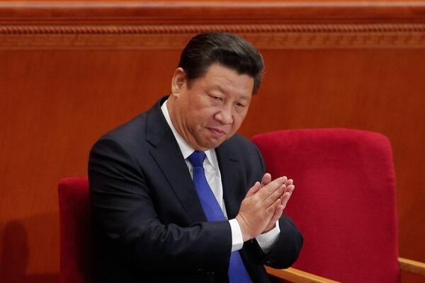 Chinese leader Xi Jinping applauds during the opening of the 3rd Session of the 12th National People's Congress at the Great Hall of the People in Beijing on March 5, 2015. (Lintao Zhang/Getty Images)