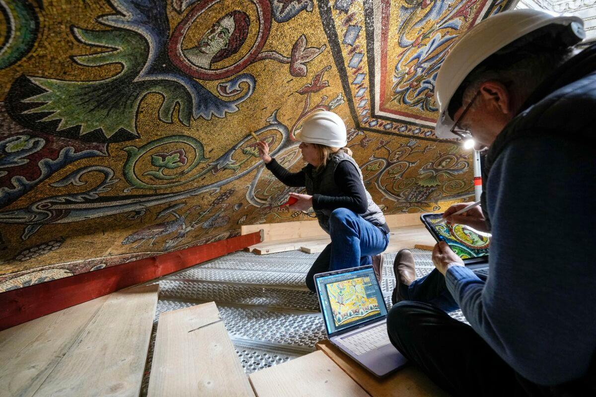 Restorers Chiara Zizola (R) and Roberto Nardi work at the restoration of the mosaics that adorn the dome of one of the oldest churches in Florence, St. John's Baptistery, in Florence, central Italy, on Feb. 7, 2023. (Andrew Medichini/AP Photo)