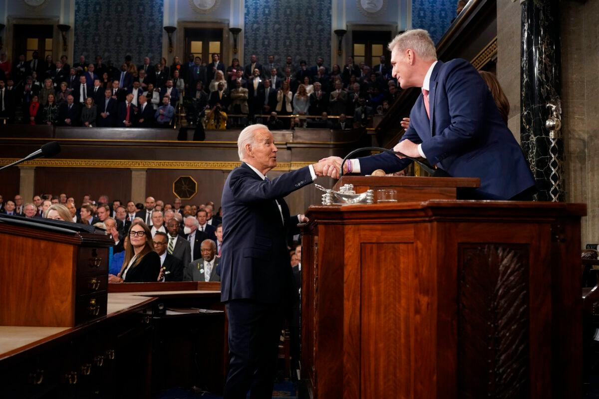 U.S. President Joe Biden shakes hands with House Speaker Kevin McCarthy (R-Calif.) before delivering the State of the Union address to a joint session of Congress in the House Chamber of the U.S. Capitol in Washington on Feb. 7, 2023. (Jacquelyn Martin-Pool/Getty Images)