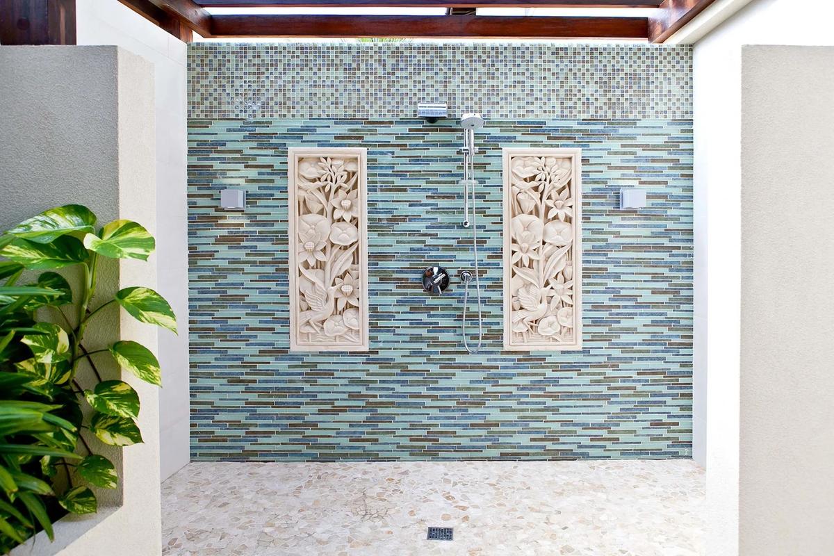 The master bedroom’s open air spa shower is finished in tiles matching those used in the vanishing-edge pool, with a no-slip stone floor. (Courtesy of Sotheby’s Concierge Auction)