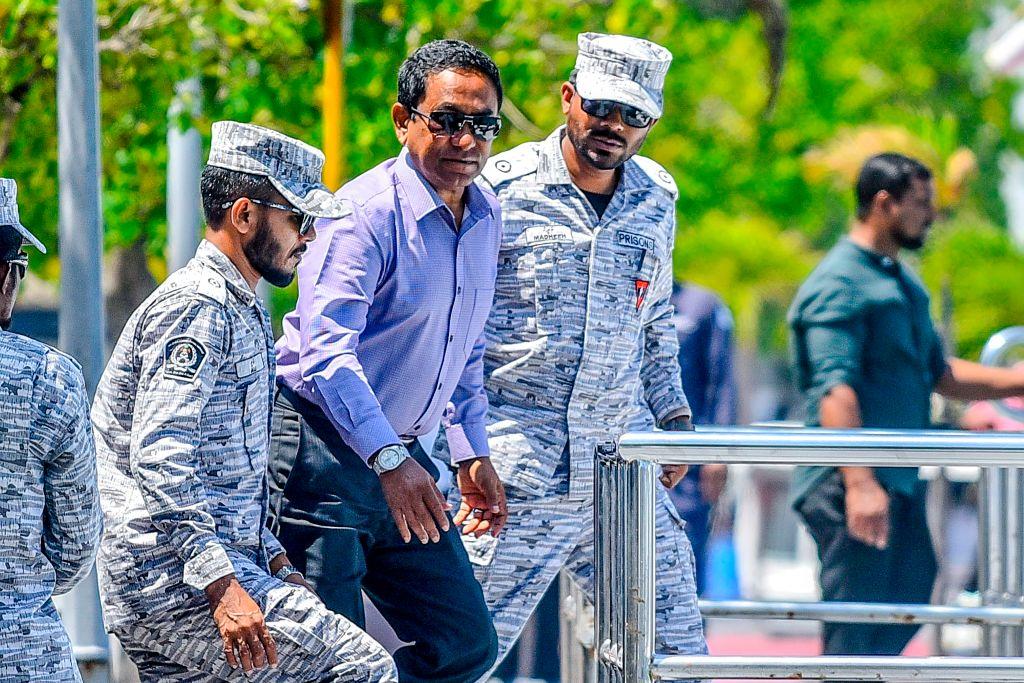 Former Maldives' president Abdulla Yameen (C) looks on as he is escorted to board a speedboat of Correctional Service heading back to prison, after the High Court ruling, in Male on February 6, 2020. - The Maldives High Court ruled on February 6 against the suspension of sentence and release on bail of ex-president Abdulla Yameen, who was sentenced to five years in prison for money laundering on November 28, 2019. (Ahmed Shurau/AFP via Getty Images)