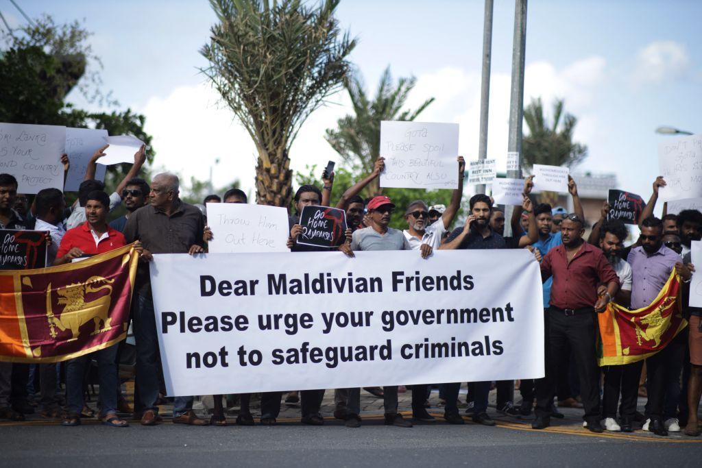 Sri Lankans living in the Maldives stage a demonstration in Male on July 13, 2022, to protest for the arrival of former President Gotabaya Rajapaksa who is fleeing his own country after thousands of protesters overran his official residence accusing him of responsibility for Sri Lanka's worst economic crisis. (Photo by AFP) (Photo by -/AFP via Getty Images)