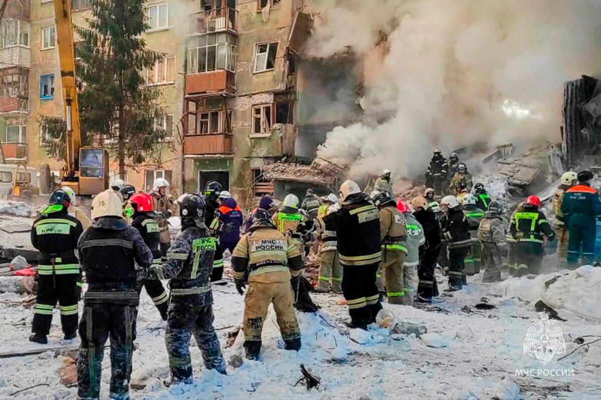Emergency service employees work at a site of a five-story residential building collapsed after a gas explosion in the Siberian city of Novosibirsk, Russia, on Feb. 9, 2023. (Russian Emergency Ministry Press Service via AP)