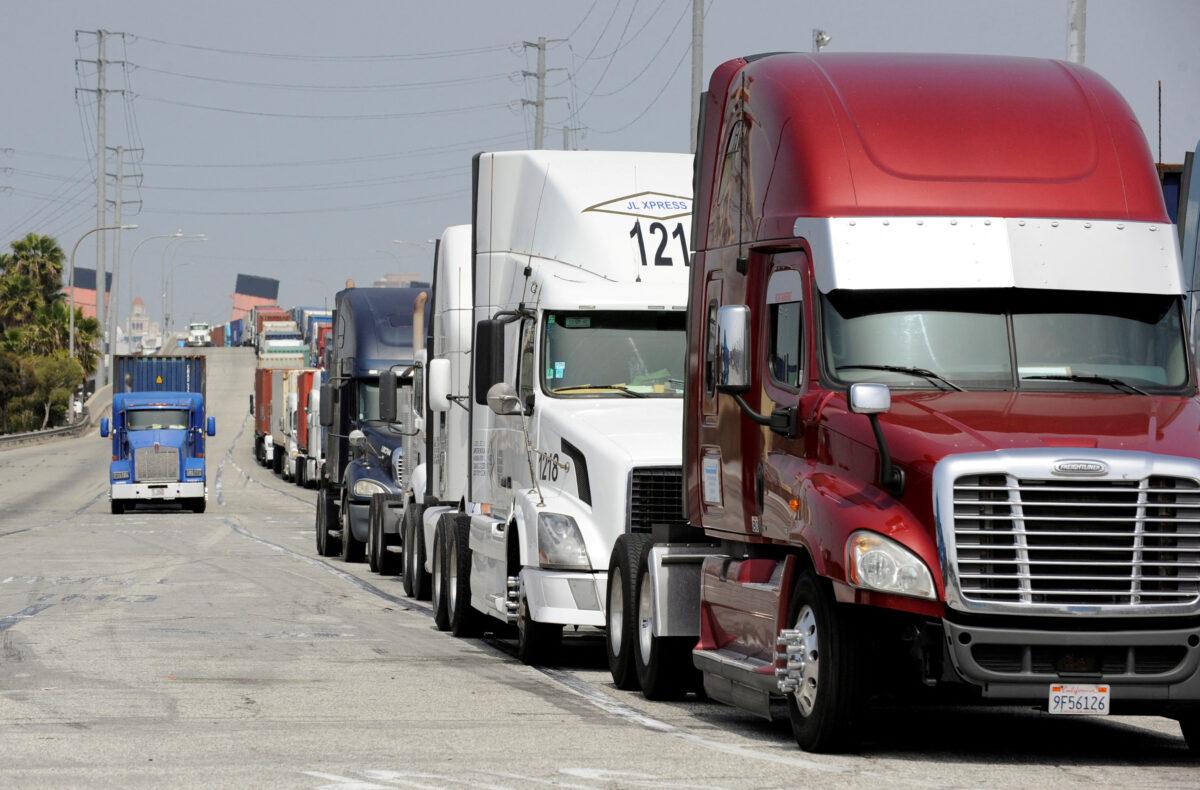 Semi-trucks line up near Pier J to retrieve shipping containers from a China-based ship at the Port of Long Beach, in Long Beach, Calif., on April 4, 2018. (Bob Riha Jr./Reuters)