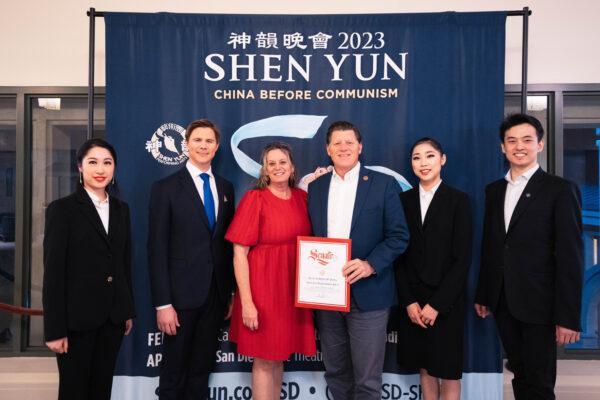 California State Senator Brian Jones (C) presents Shen Yun Performing Arts' emcees (L) and principal dancers (R) with a welcome certificate at the California Center for the Arts, in Escondido, on Feb. 9, 2023. (Hu Yudi/The Epoch Times)